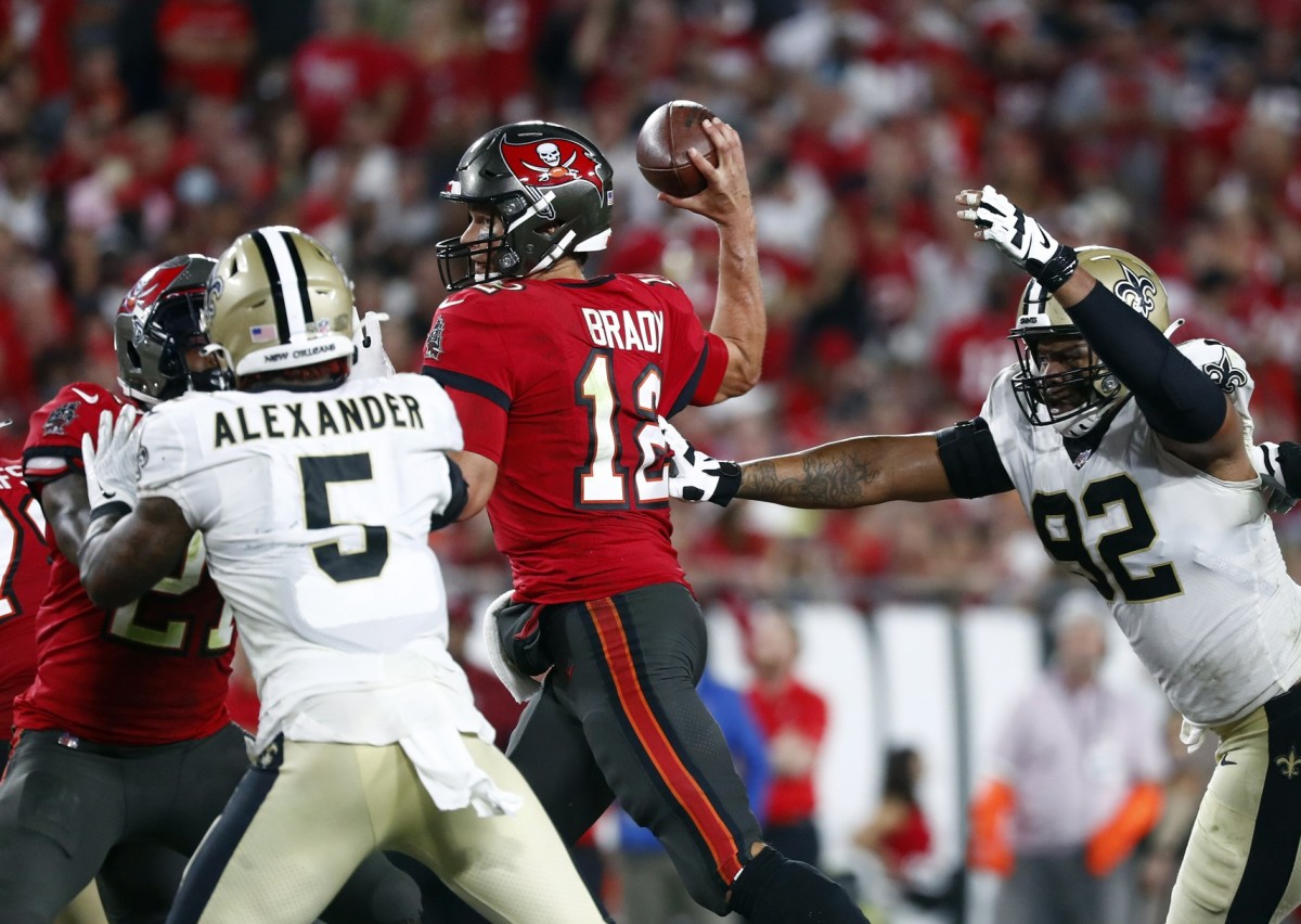 Tampa Bay Buccaneers quarterback Tom Brady (12) throws under pressure from Saints linebacker Kwon Alexander (5) and defensive end Marcus Davenport (92). Mandatory Credit: Kim Klement-USA TODAY 